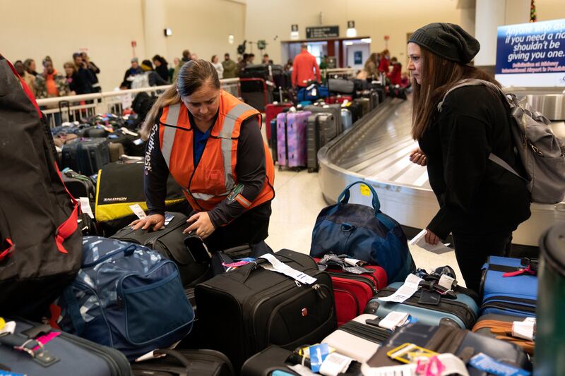A Southwest employee helps a traveller search for bags at Midway International Airport in Chicago, Illinois. AP