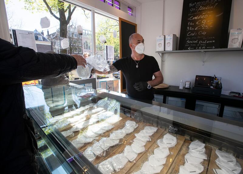 NETHERLANDS: A salesperson in a converted ice cream parlour, sells his FFP2 face masks at 9 euros a piece, or 3 for 25 euros, as protection against the coronavirus in Amsterdam, on April 19, 2020. AP Photo