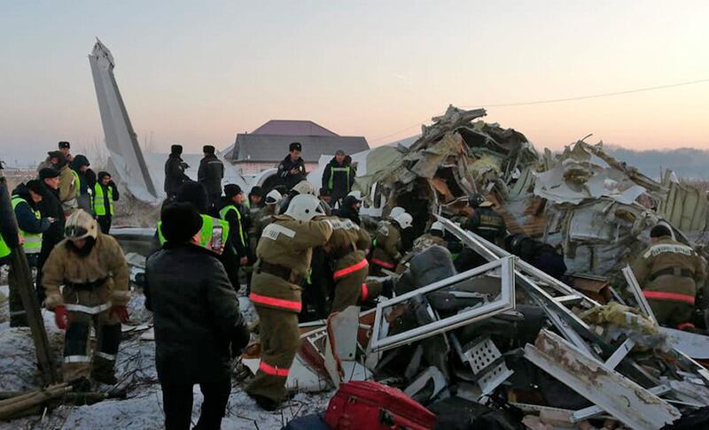 In this handout photo provided by the Emergency Situations Ministry of the Republic of Kazakhstan, police and rescuers work on the site of a plane crash near Almaty International Airport, outside Almaty, Kazakhstan. AP