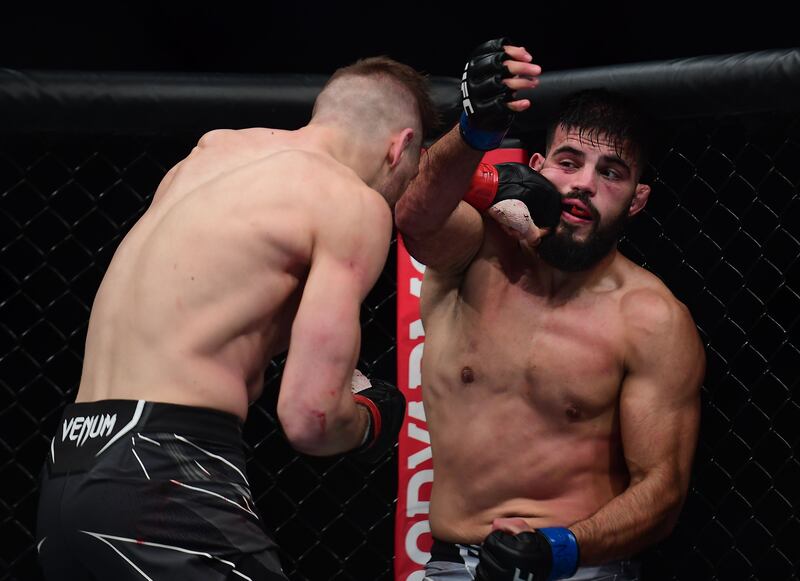 an Hooker lands a hit against Nasrat Haqparast during UFC 266. Reuters