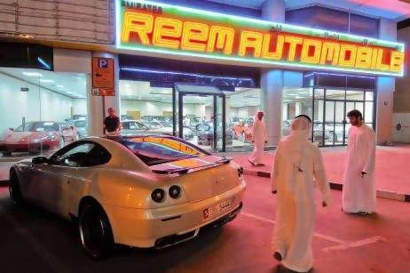 Emiratis check out a  used Ferrari 612 Scaglietti outside Reem Automoblies in Dubai, United Arab Emirates on Aug. 30, 2010. Photo: Charles Crowell for the National