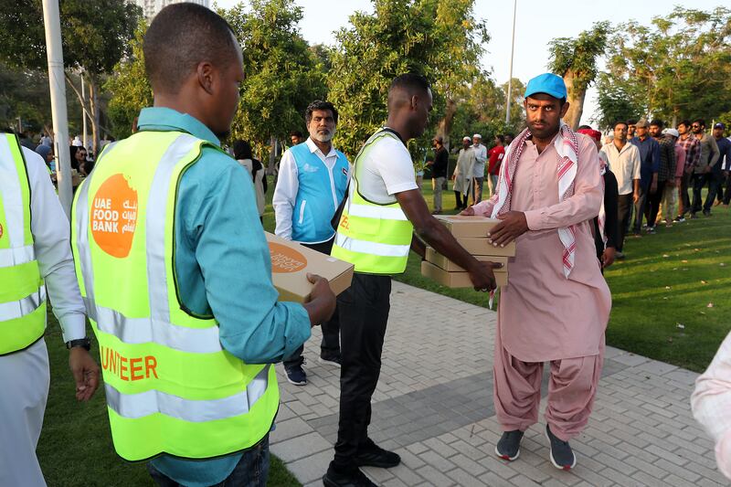 Food is distributed to workers under the 1,000 Meals campaign, part of the UAE Food Bank programme held at Zabeel Park. Pawan Singh / The National
