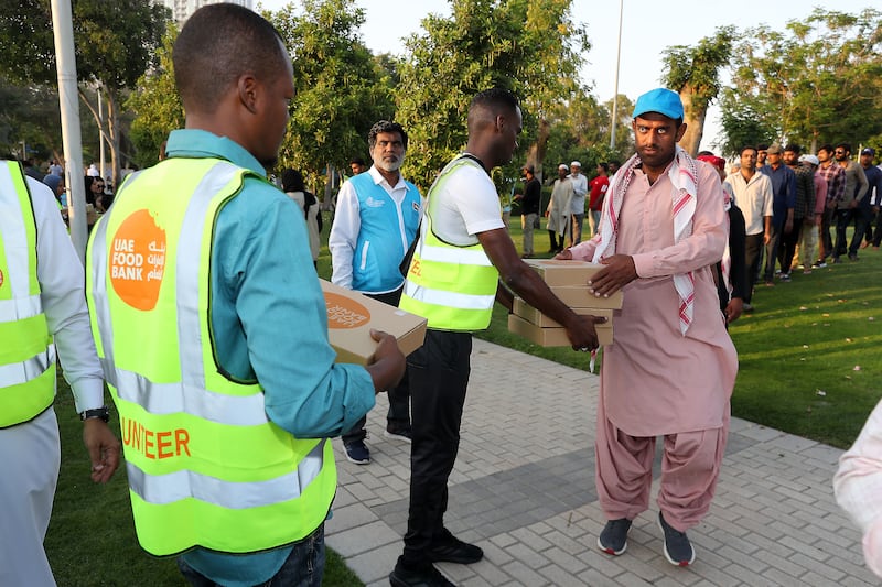 Food is distributed to workers under the 1,000 Meals campaign, part of the UAE Food Bank programme held at Zabeel Park. Pawan Singh / The National