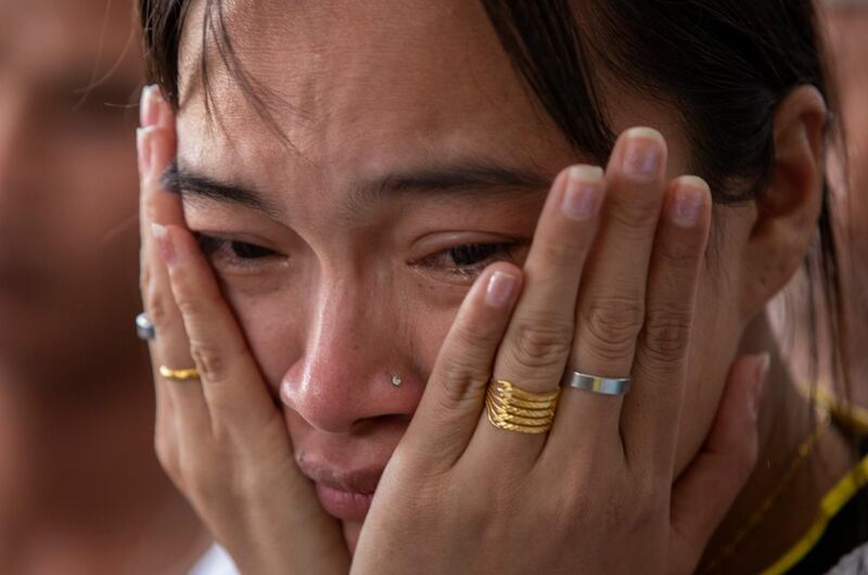 A relative of a missing person waits outside the emergency room where victims of the mass shooting are being treated in Korat, Nakhon Ratchasima, Thailand. AP Photo