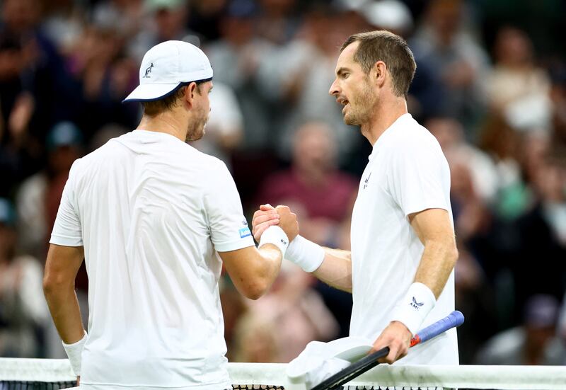 Andy Murray and James Duckworth shake hands after their first round match at Wimbledon. Reuters