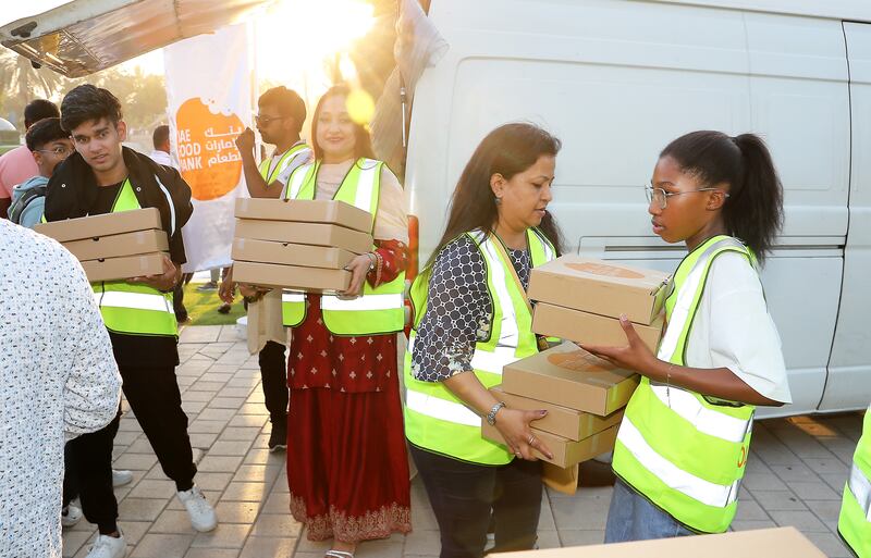 Volunteers distribute iftar meals as part of the UAE Food Bank drive at Zabeel Park, Dubai. Pawan Singh / The National