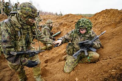 Estonian soldiers defend a dug-in position attacked by British troops posing as enemy fighters during exercises in the Baltic country. PA 
