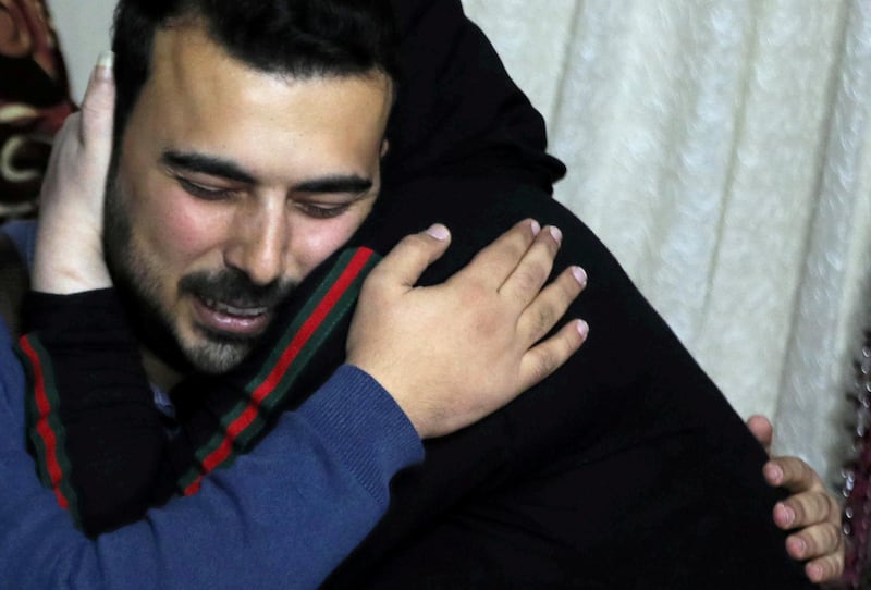 Amjad Yaghi hugs his mother, Nevine, after 20 years of separation. Reuters