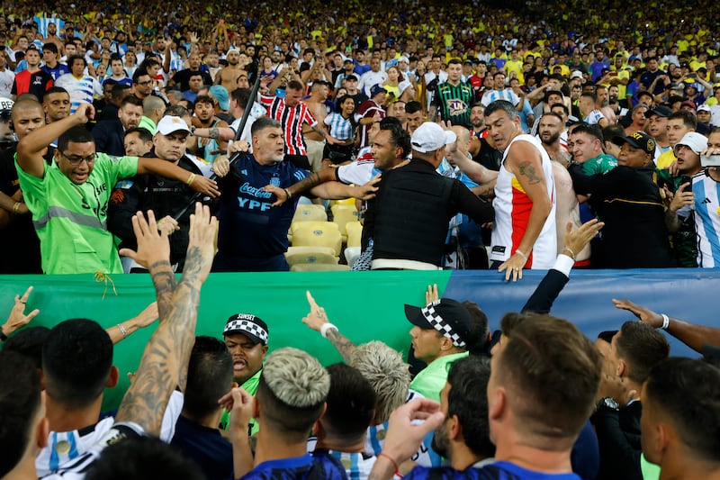 Argentina players attempt to diffuse the situation as police officers clash with fans in the stands. Getty Images