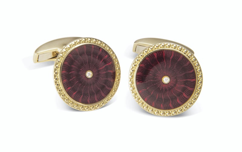 Round cufflinks in 18K yellow gold with orange enamel and diamond centre; Dh15,000. Courtesy Deakin & Francis