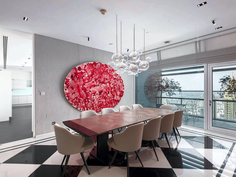 A splash of red breaking up the monochrome in the formal dining room. Courtesy Luxhabitat Sotheby's International Realty