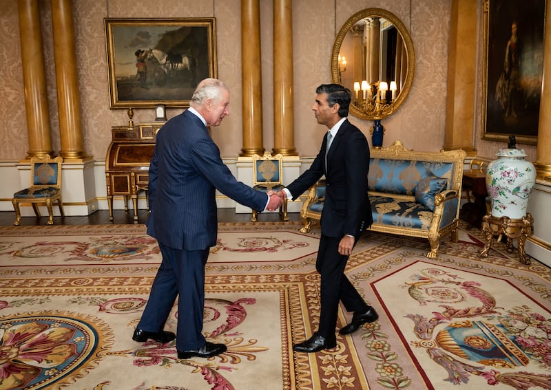Greeting Mr Sunak at Buckingham Palace on his appointment as Prime Minister. AFP