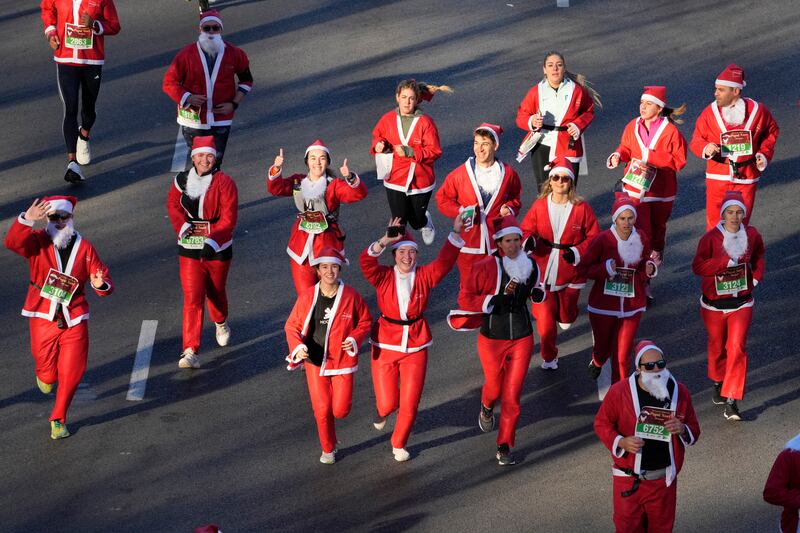 People dressed in Santa Claus costumes take part in a morning run on Christmas Eve in Madrid. AP