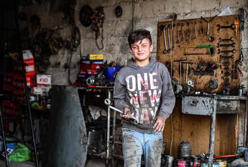 A young Syrian boy works at a car repair shop in the town of Jandaris, in the countryside of the north-western city of Afrin in the rebel-held part of Aleppo province, a day before the annual World Day Against Child Labour. All photos by AFP
