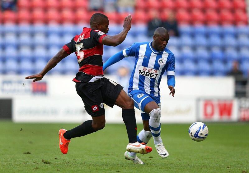 Marc-Antoine Fortune of Wigan Athletic takes on Nedum Onuoha of Queens Park Rangers during the Championship play-off semi-final first leg match at DW Stadium on Friday. Alex Livesey / Getty Images / May 9, 2014  
