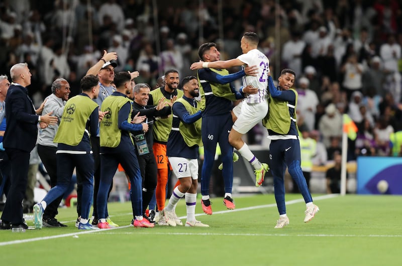 Al Ain's Soufiane Rahimi celebrates with the substitutes' bench after scoring the first goal. 