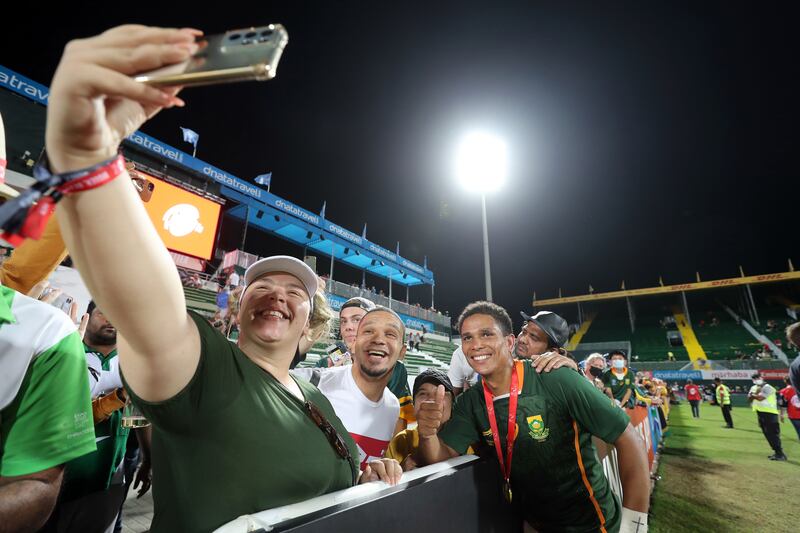 Supporters at the Dubai Sevens take selfies with South Africa players..