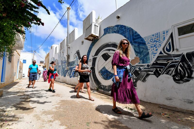 Tourists walk through the alleys of the Hara Kebira, the main Jewish quarter in Djerba. AFP
