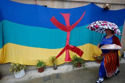 epa08122583 A woman walks next to a Berber flag as Algerian Berbers celebrate New Year 2970 in Sahel village, south of Tizi-Ouzou, east of Algiers, 12 January 2020. Berbers, an ethnic group from the pre-Arab populations of North Africa, are currently celebrating their New Year. Yennayer, the first month of the Berber Year, is marked as a national holiday in Algeria for the third time.  EPA/STRINGER