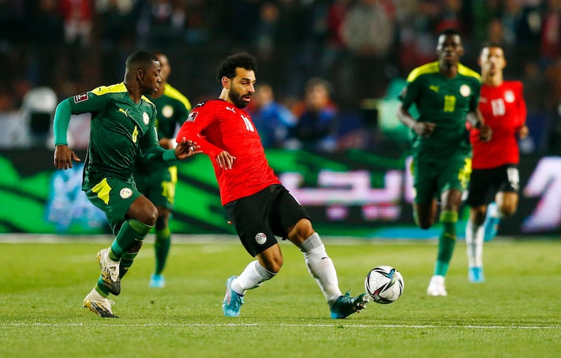 Mohamed Salah takes on Senegal's Nampalys Mendy. Reuters