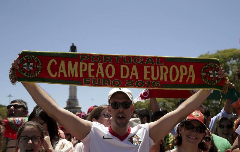 Portugal national soccer team supporter holds a scarf with the words ‘Portugal European Champion Euro 2016’ in front of the Belem palace in Lisbon, Portugal, 11 July 2016. The Portugal national soccer team on 10 July 2016 had won the UEFA Euro 2016 final against France by 1-0 to win the title for first time.  EPA/ANTONIO COTRIM