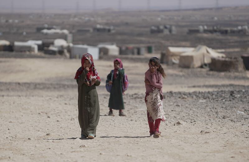 Girls return from school at a camp for internally displaced people in Marib, Yemen. Reuters