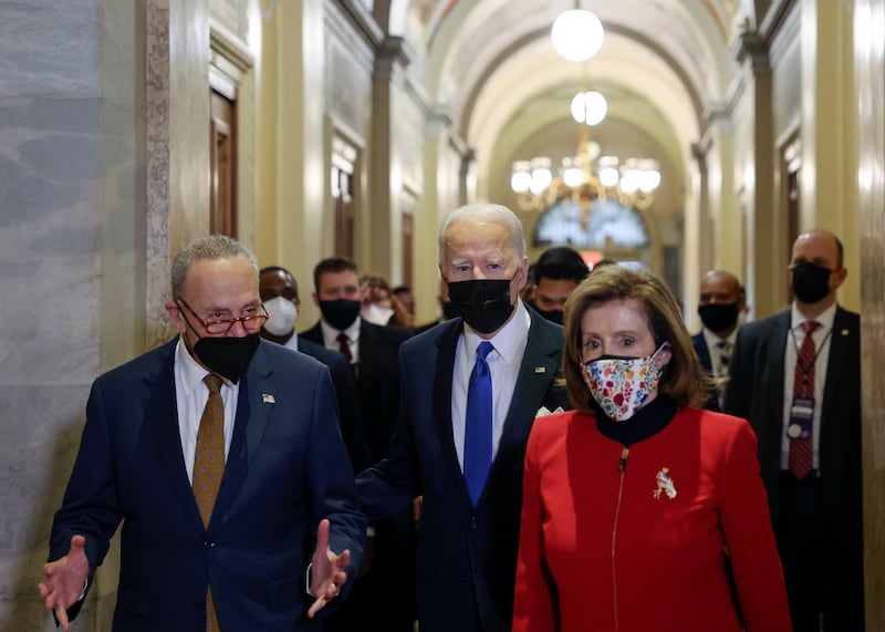 US President Joe Biden with Ms Pelosi and Senate Majority Leader Chuck Schumer in the US Capitol on January 6, 2022. AP