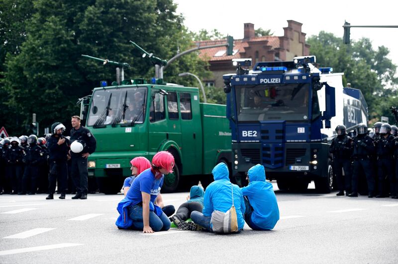 German police look on as protesters sit on a street. Fabian Bimmer / Reuters