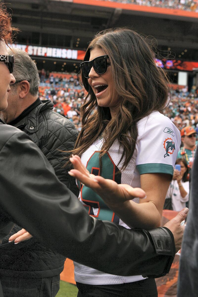 MIAMI - JANUARY 03: Performing artist Fergie greets fellow performing artist Gloria Estefan on the field before the Pittsburgh Steelers take on the Miami Dolphins at Land Shark Stadium on January 3, 2010 in Miami, Florida.   Doug Benc/Getty Images/AFP