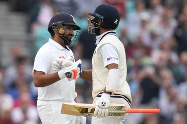 India's Rohit Sharma, left, celebrates scoring 100 runs with batting partner India's Cheteshwar Pujara on day three of the fourth Test match at The Oval cricket ground in London, Saturday, Sept.  4, 2021.  (AP Photo / Kirsty Wigglesworth)