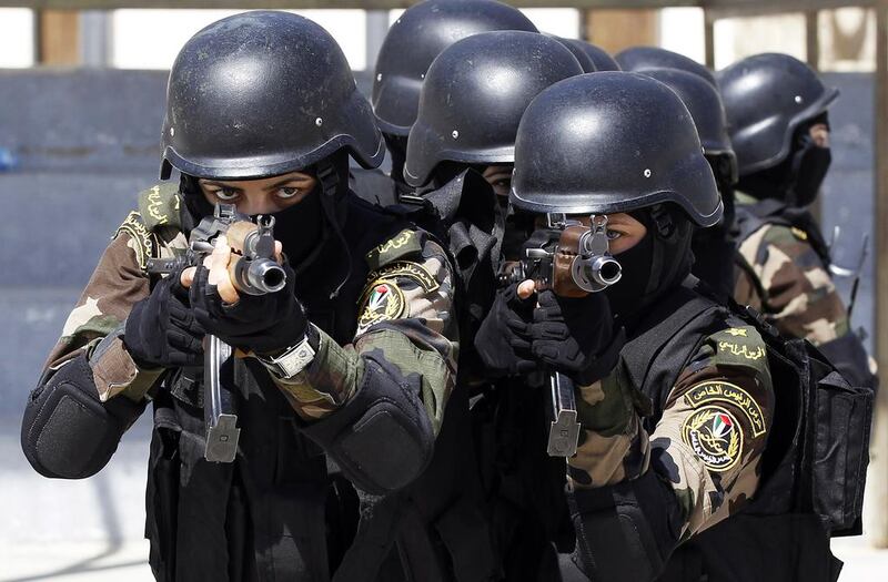 Female members of the Palestinian presidential guard take part in a training session in the West Bank city of Jericho April 6, 2014. Ammar Awad / Reuters