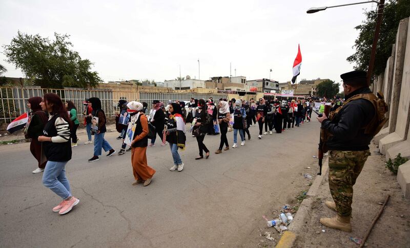 An Iraqi soldier stands guard as Iraqi university students take part in a strike and protests in central Baghdad.  EPA