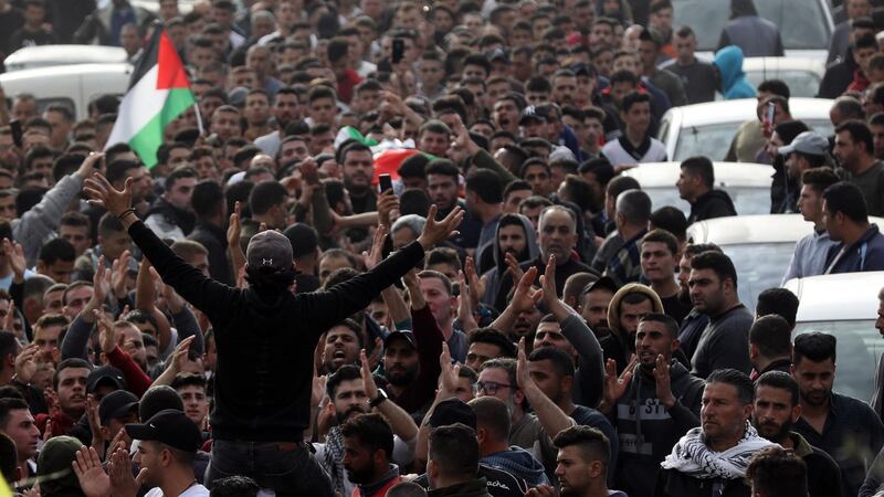 Mourners carry the body of Mohammed Hamayel, a 15-year-old Palestinian killed by Israeli forces, during his funeral in the West Bank village of Beita on March 11, 2020.  EPA