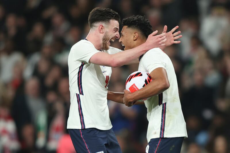 Ollie Watkins, right, celebrates after he scoring England's  first goal in their 3-0 friendly win against the Ivory Coast at Wembley Stadium on Tuesday, March 29, 2022. AP