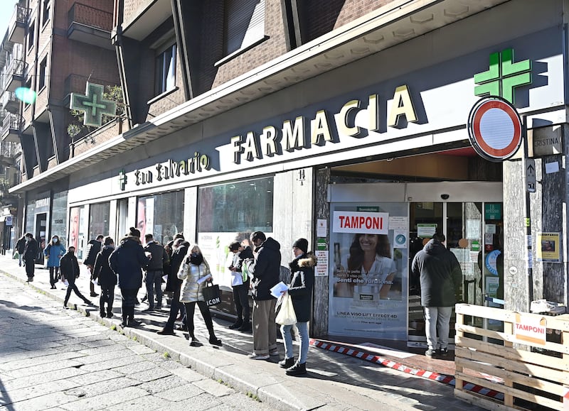 People queue up outside a pharmacy to have swab tests in Turin, Italy. EPA