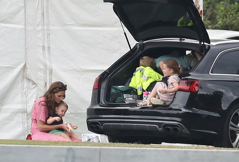 Catherine, Duchess of Cambridge sits with Prince Louis, while Prince George and Princess Charlotte are in the back of the car, during the King Power Royal Charity Polo Day. AP