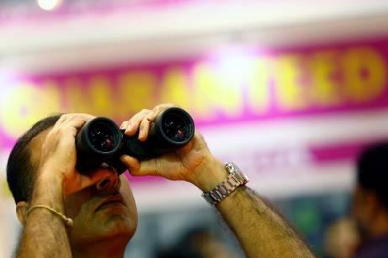 Dubai, United Arab Emirates- April, 03, 2013: Visitor trys the new Binoculars during the Gitex Shoppers-2013 at the Dubai World Trade Centre in Dubai .  (  Satish Kumar / The National ) For Business