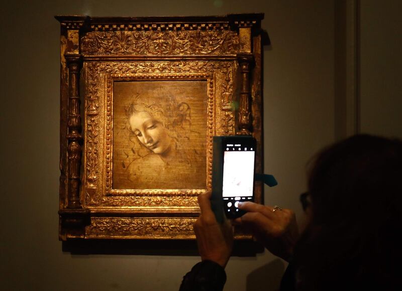 An oil on wood painting by Leonardo da Vinci's  " The Head of a Woman—also known as La Scapigliata ", during the opening of the exhibition " Leonardo da Vinci at the Louvre museum in Paris. AFP