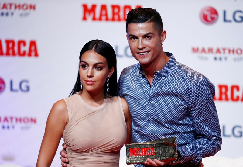 Soccer Football - Cristiano Ronaldo receives the MARCA Legend award - Reina Victoria Theater, Madrid, Spain - July 29, 2019   Cristiano Ronaldo poses with partner Georgina Rodriguez and the MARCA Legend award   REUTERS/Juan Medina