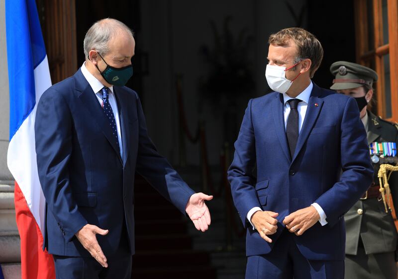 Irish Prime Minister Micheal Martin, left, greets French president Emmanuel Macron in Dublin. AP