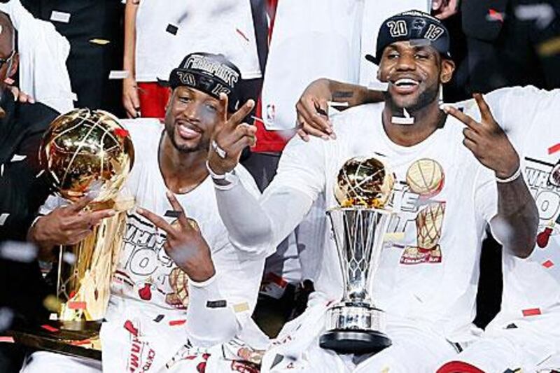 Dwyane Wade and LeBron James celebrate after defeating the San Antonio Spurs 95-88 to win Game Seven and the NBA championships. Kevin C Cox / Getty Images / AFP Photo