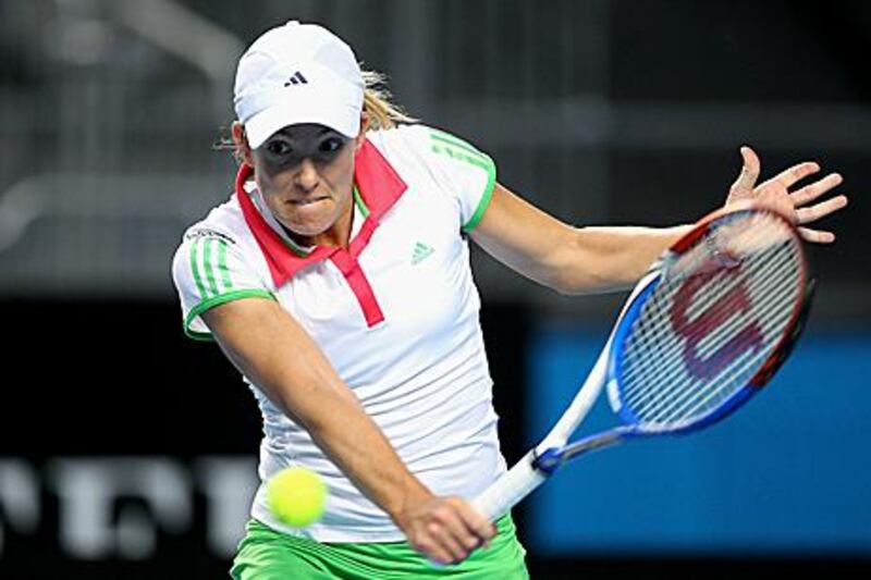 Justine Henin returns during her first-round match against Sania Mirza.