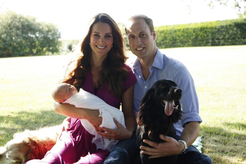 PICTURE EMBARGOED UNTIL 00:01hrs BRITISH SUMMER TIME ON TUESDAY 20th AUGUST 2013 (23:01 GMT ON MONDAY 19th AUGUST) 

A handout picture released on August 19, 2013 by  Kensington Palace shows Prince William, Duke of Cambridge, his wife Catherine, Duchess of Cambridge, with their newborn baby boy, Prince George of Cambridge, Tilly the retriever (L), a Middleton family pet and Lupo, the couple's cocker spaniel (R) at the Middleton family home in Bucklebury, Berkshire, in early August, 2013. The couple released two family photographs with their son, Prince George, taken by Michael Middleton, Catherine's father, in early August in the garden of the Middleton family home. AFP PHOTO/HO/MICHAEL MIDDLETON/MICHAEL MIDDLETON

== RESTRICTED TO EDITORIAL USE - MANDATORY CREDIT "AFP PHOTO / DUKE AND DUCHESS OF CAMBRIDGE /  MICHAEL MIDDLETON " - NO MARKETING NO ADVERTISING CAMPAIGNS - DISTRIBUTED AS A SERVICE TO CLIENTS - NO SALE == (Photo by MICHAEL MIDDLETON / Duke and Duchess of Cambridge / AFP)
