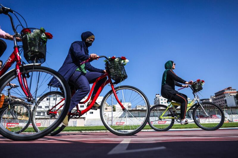 Palestinian women ride bicycles at the Yarmouk Stadium in Gaza city. AFP