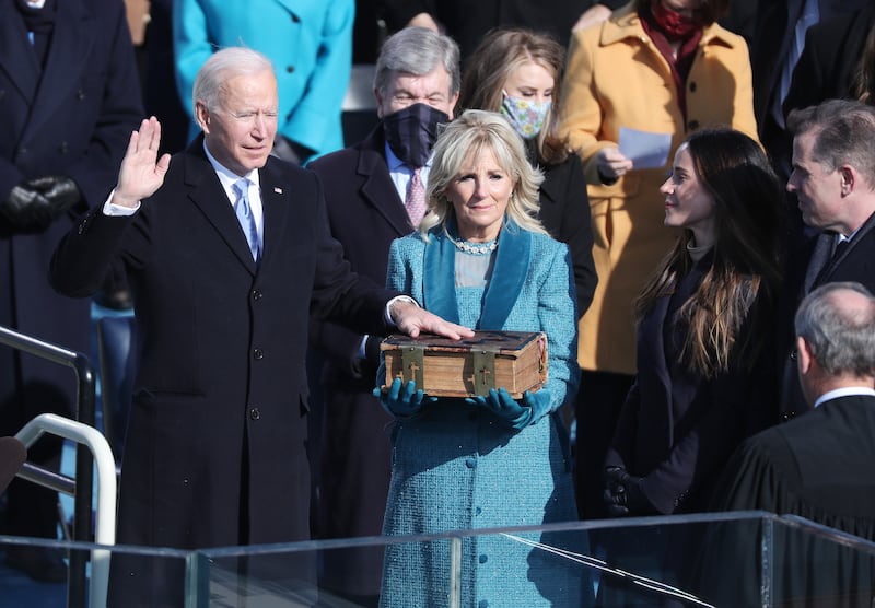 Joe Biden stands with his wife, Jill Biden, as he is given the oath of office by Chief Justice John Roberts of the Supreme Court. EPA