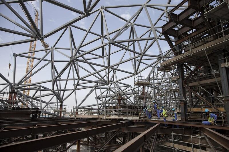 March 13, 2014: Men work on creating a work platform, high in the air, just beneath the future iconic dome structure at the Louvre Abu Dhabi construction site. One year after the start of construction, the museum is already taking shape. Silvia Razgova / The National