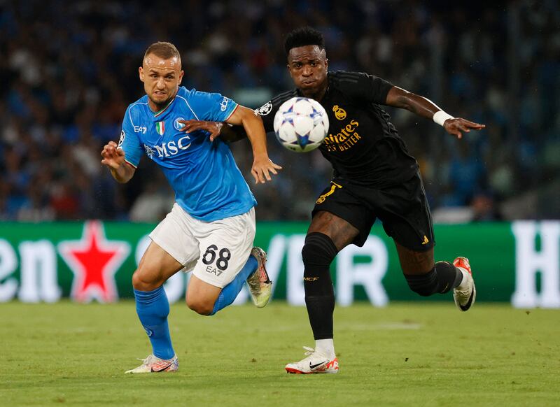 Napoli's Stanislav Lobotka vies for the ball with Real Madrid's Vinicius Junior. Reuters
