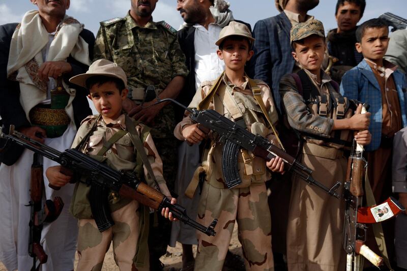 Yemeni children carrying weapons take part in a gathering organised by Shiite Huthi rebels to mobilise more fighters to battlefronts to fight pro-government forces, on June 18, 2017, in the capital Sanaa. (Photo by MOHAMMED HUWAIS / AFP)