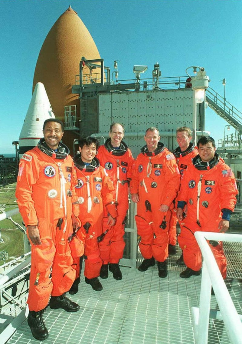 Pumpkin Suit - Space Shuttle Endeavour crew (L-R) Winston Scott, Japanese Astronaut Koichi Wakata, Dan Barry, Commander Brian Duffy, Pilot Brent Jett and Leroy Chiao pose for photo 12 December on the service structure at Kennedy Space Center's Launch Pad 39-B.  The Mission STS-72 crew are in Florida to participate in training and a practice countdown for their planned 11 January mission to retrieve and return a Japanese satellite.       AFP PHOTO   NASA (Photo by NASA PHOTO / AFP)