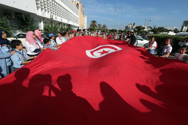 epa07107553 Tunisian people hold national flag during the celebration of 191 years of creation Tunisian flag in Tunis, Tunisia on 20 October 2018. On 20 October 1827, Hussein II Bey ( Ottoman Empire ) decided on its creation which was effective in 1831. It remained official during the French protectorate and the Constitution of 01 June 1959 confirms the function of national flag of the Tunisian Republic. But it was not until 30 June 1999 that its proportions and motives were clearly specified at the level of the law.  EPA/MOHAMED MESSARA